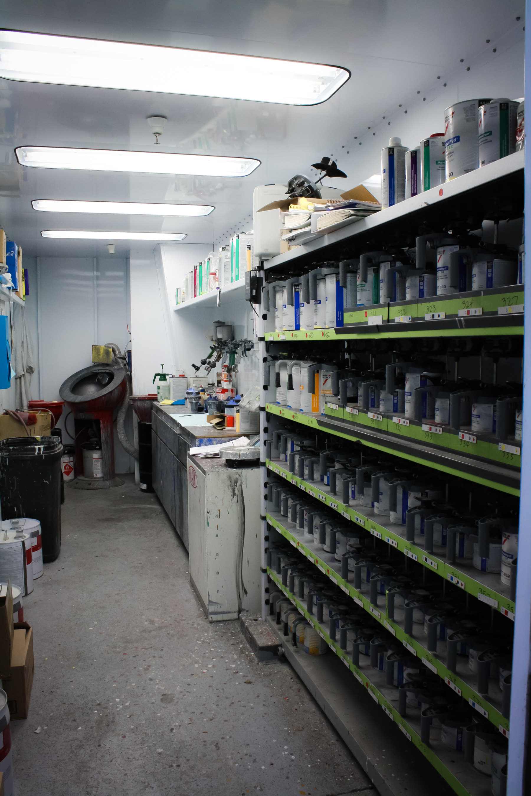 The paint mixing room at California Color, shelves of tinted paint and mixing equipment.